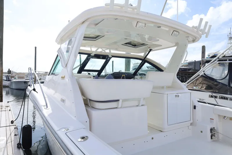 Slide: The Image of 2009 Tiara Yachts 32 Open, white exterior, docked at marina, spacious cockpit area. - 5