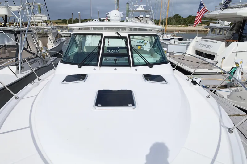 Slide: The Image of 2009 Tiara Yachts 32 Open docked, showcasing sleek design and spacious deck. - 6