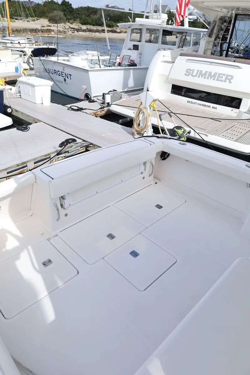 Slide: The Image of 2009 Tiara Yachts 32 Open boat deck, docked with other vessels in a marina. - 9