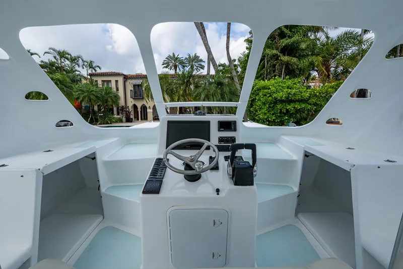 Slide: The Image of Cockpit of 2019 Aventura 31 Cat boat with steering wheel and control panel. - 11