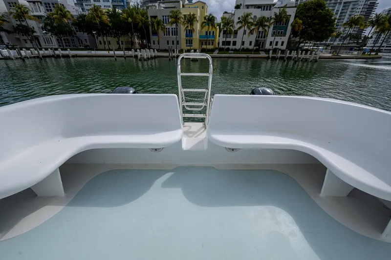 Slide: The Image of 2019 Aventura 31 Cat boat with spacious seating, overlooking a serene waterfront view. - 17