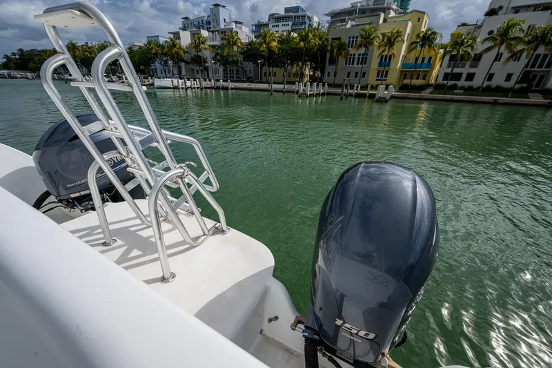 Slide: The Image of Aventura 31 Cat 2019 boat with dual engines docked by waterfront buildings. - 19