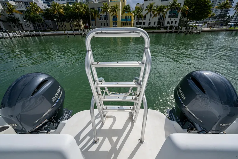 Slide: The Image of 2019 Aventura 31 Cat boat with dual Yamaha engines and a rear ladder on a calm waterway. - 20