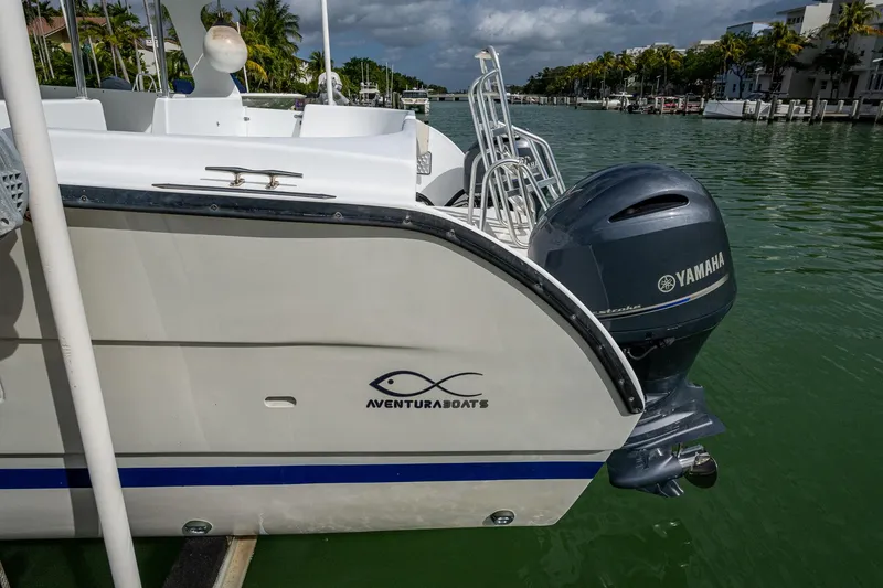 Slide: The Image of 2019 Aventura 31 Cat boat with Yamaha engine docked on a sunny day. - 23