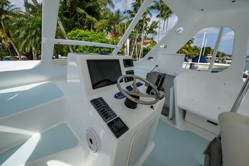 Slide: The Image of Aventura 31 Cat 2019 boat cockpit with steering wheel and navigation controls. - 6