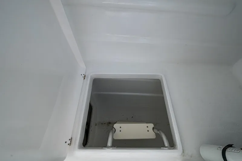 Slide: The Image of Storage compartment in 2019 Aventura 31 Cat boat, featuring a clean, white interior. - 7