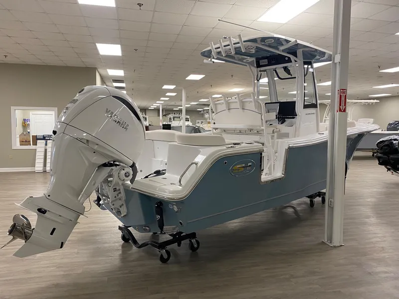 Slide: The Image of 2025 Sea Hunt Ultra 245 SE boat with Yamaha engine in showroom. - 4