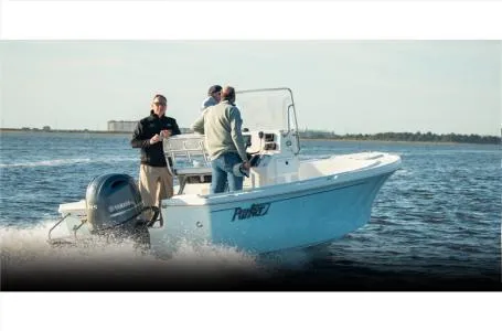 Slide: The Image of 2025 Parker 18SE boat cruising on open water with three people onboard. - 5