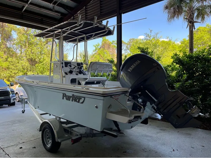 Slide: The Image of 2025 Parker 18SE boat with Yamaha engine, parked under a shelter. - 8