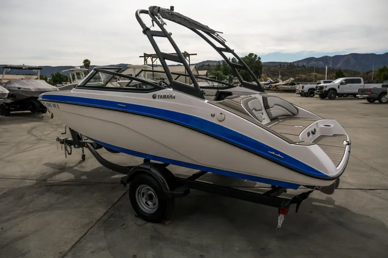 Slide: The Image of 2019 Yamaha Boats AR 190 on trailer, parked outdoors, showcasing sleek design and blue accents. - 11