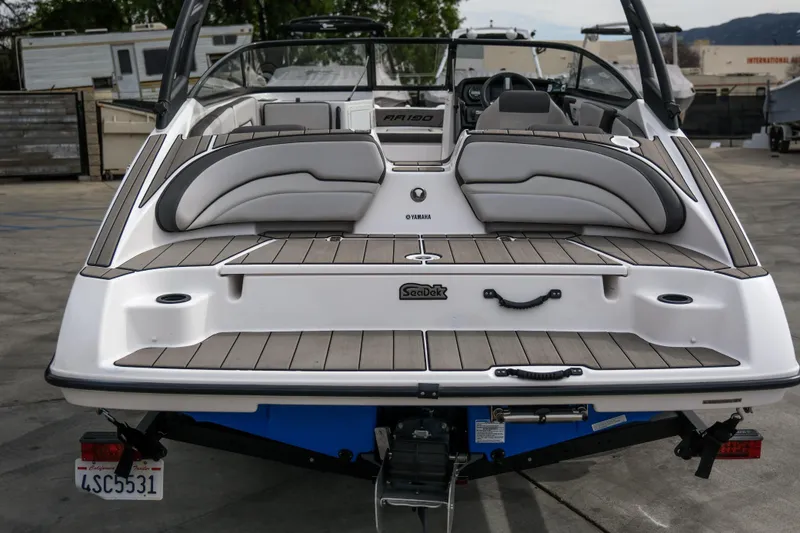Slide: The Image of 2019 Yamaha Boats AR 190, rear view, showcasing spacious deck and seating area. - 6