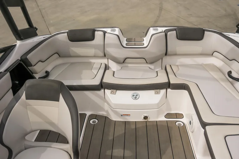 Slide: The Image of 2019 Yamaha Boats AR 190 interior seating with gray and white upholstery. - 8