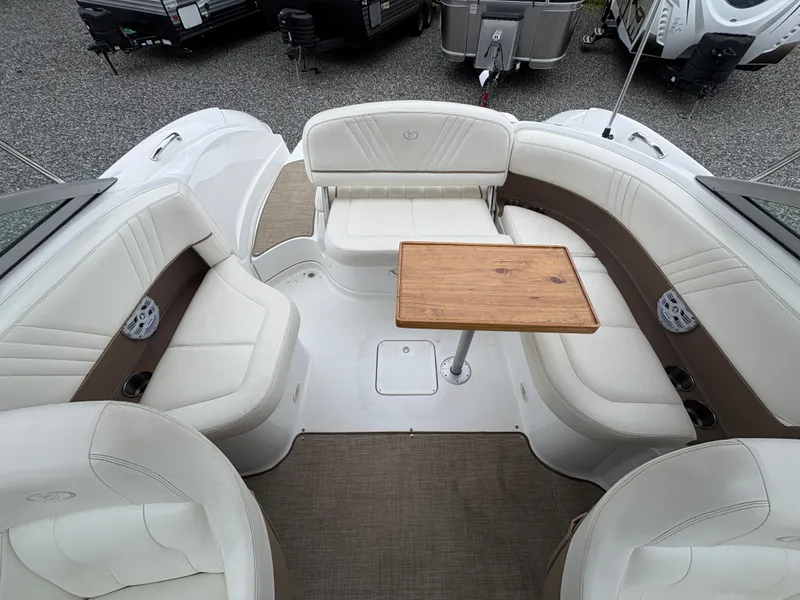 Slide: The Image of 2007 Cobalt 232 Bowrider interior with white seating and wooden table. - 10