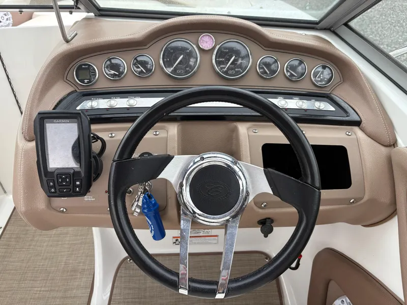 Slide: The Image of Steering wheel and dashboard of a 2007 Cobalt 232 Bowrider boat. - 13