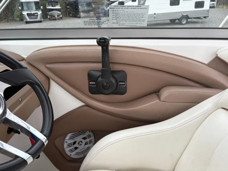 Slide: The Image of Interior of a 2007 Cobalt 232 Bowrider boat, featuring steering wheel and control panel. - 14