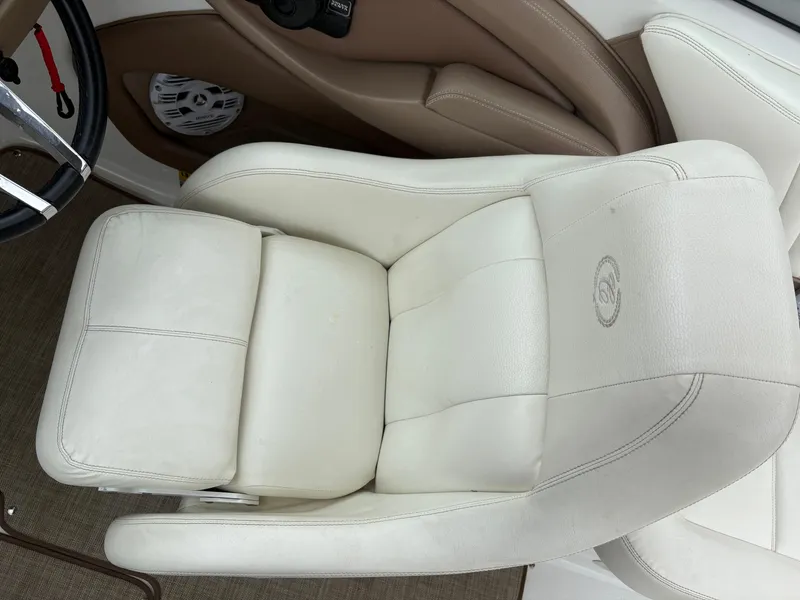 Slide: The Image of 2007 Cobalt 232 Bowrider boat seat, white leather upholstery, steering wheel visible. - 15