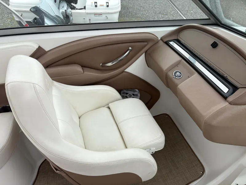 Slide: The Image of 2007 Cobalt 232 Bowrider interior with white and tan seating, dashboard, and steering wheel. - 16