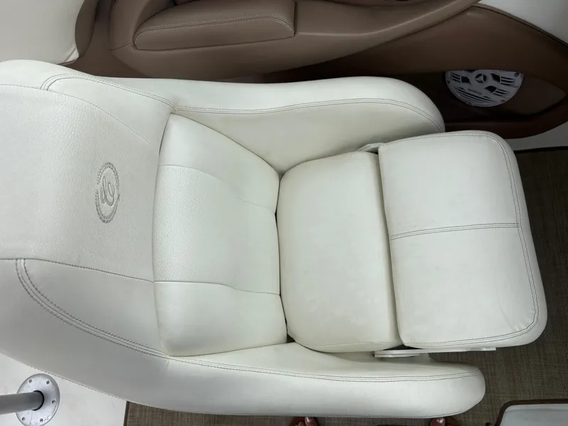 Slide: The Image of White leather seat in a 2007 Cobalt 232 Bowrider boat interior. - 17