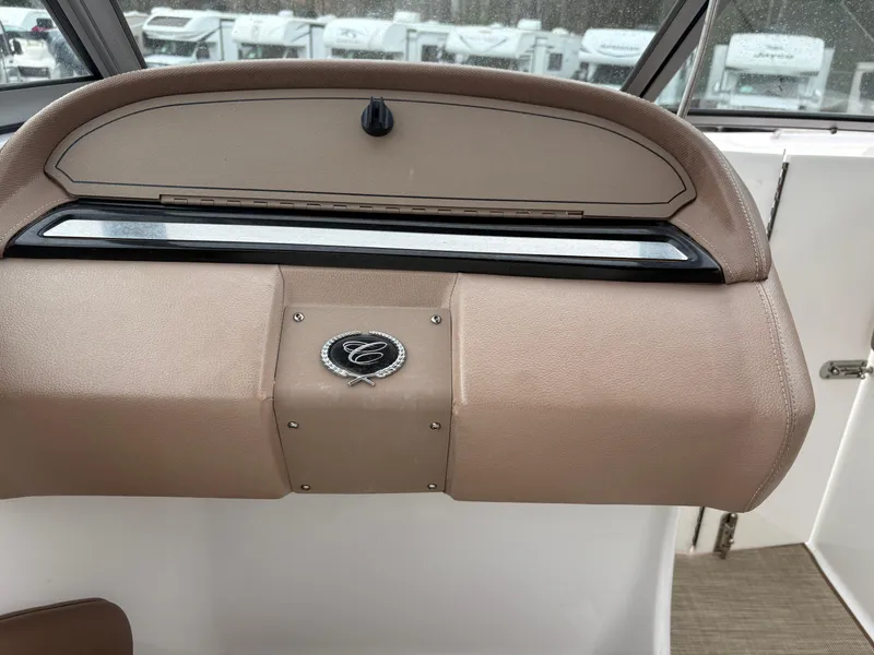 Slide: The Image of 2007 Cobalt 232 Bowrider dashboard with emblem, beige interior, and windshield view. - 18