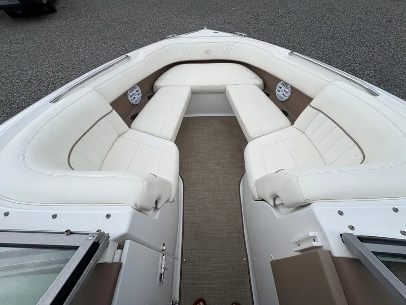 Slide: The Image of 2007 Cobalt 232 Bowrider boat interior with white cushioned seating and carpeted floor. - 20