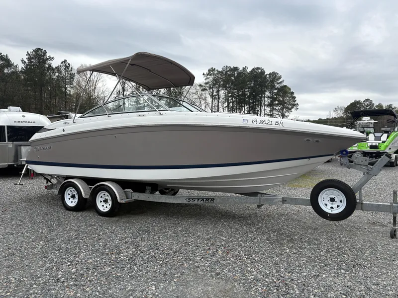 Slide: The Image of 2007 Cobalt 232 Bowrider boat on trailer, parked outdoors, overcast sky. - 5