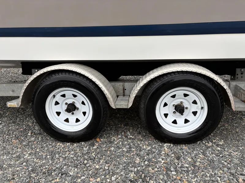 Slide: The Image of Trailer wheels of a 2007 Cobalt 232 Bowrider on gravel surface. - 7