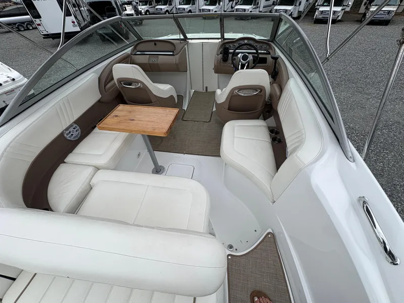 Slide: The Image of 2007 Cobalt 232 Bowrider interior with white seating and wooden table. - 9