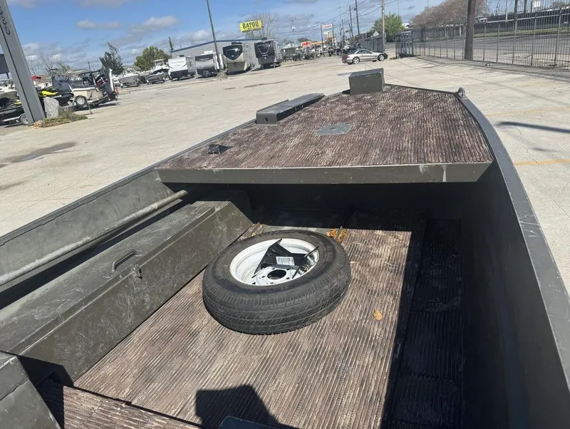 Slide: The Image of 2018 Go-Devil 18 boat with spare tire on deck, parked outdoors. - 6