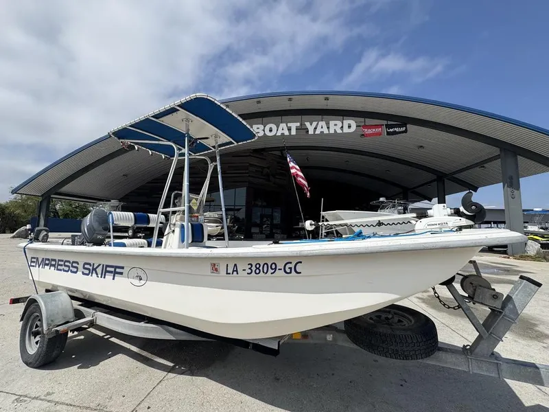 Slide: The Image of 2010 Carolina Skiff DLV 178 boat on trailer at boat yard, American flag displayed. - 3