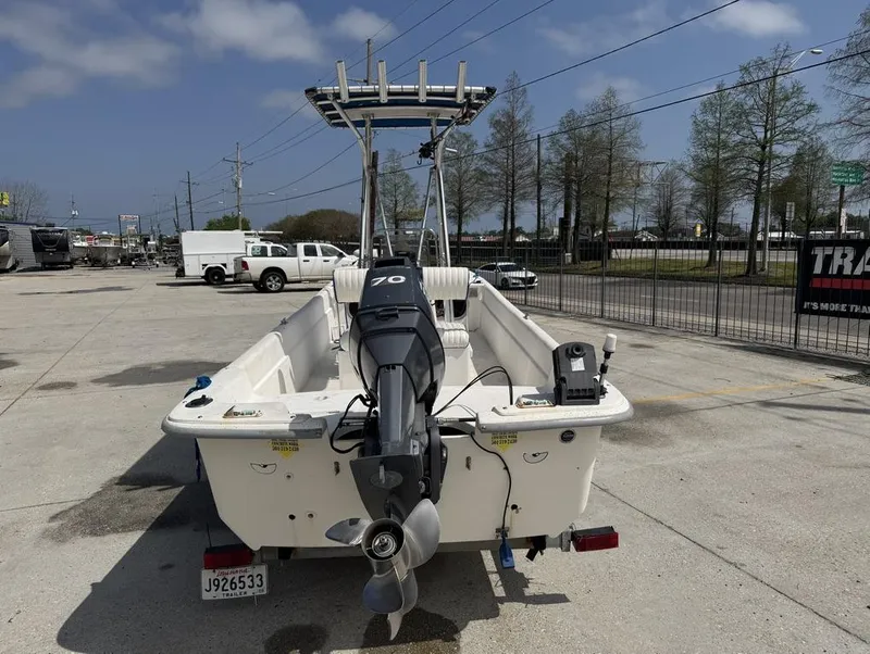 Slide: The Image of 2010 Carolina Skiff DLV 178 boat with outboard motor in a parking lot. - 5