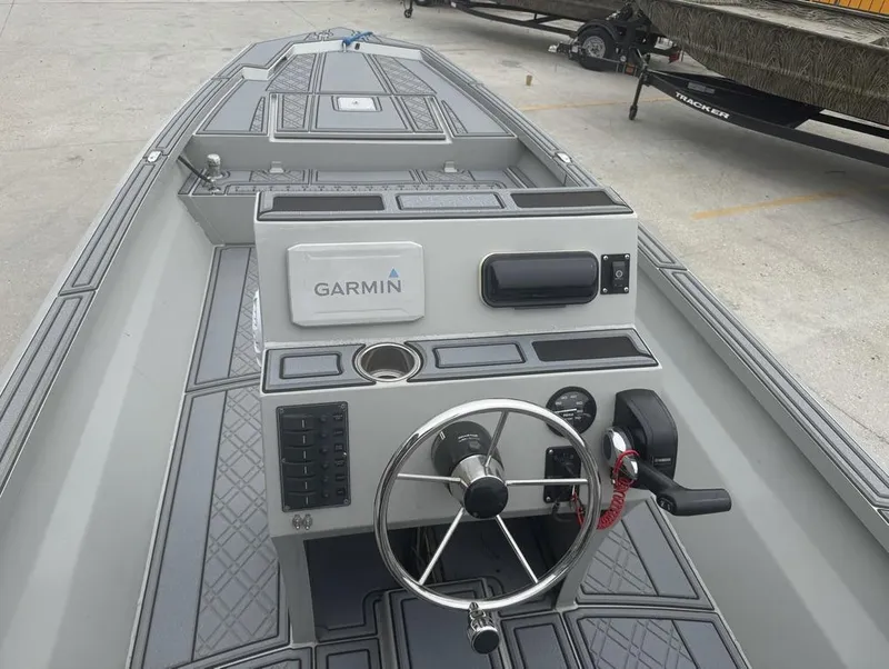 Slide: The Image of 2023 Rene Gros Custom 20 boat dashboard with Garmin navigation system and steering wheel. - 12