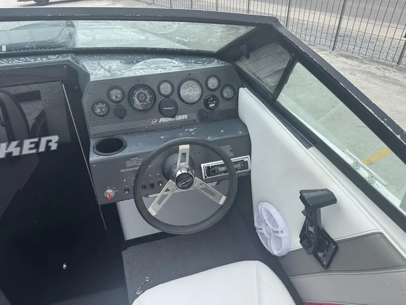 Slide: The Image of Interior of a 1990 Rinker 206 Captiva Cuddy boat showing steering wheel and dashboard controls. - 13