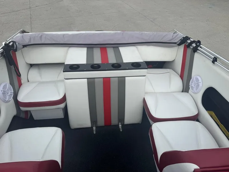 Slide: The Image of Interior of a 1990 Rinker 206 Captiva Cuddy boat with red and white seating. - 14