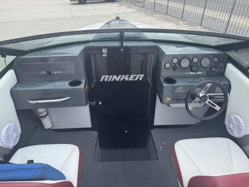 Slide: The Image of Interior of 1990 Rinker 206 Captiva Cuddy boat with steering wheel and dashboard controls. - 9