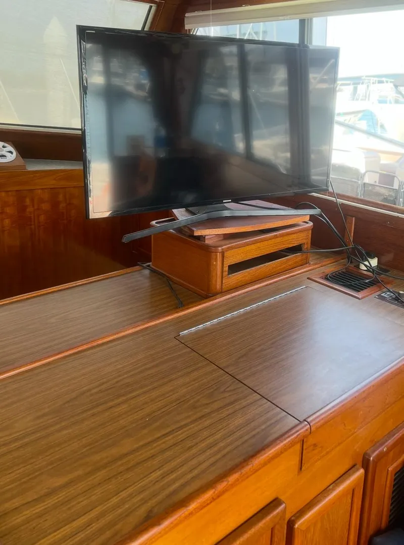 Slide: The Image of 1988 Jersey 40FT Convertible interior with TV and wooden cabinetry. - 10