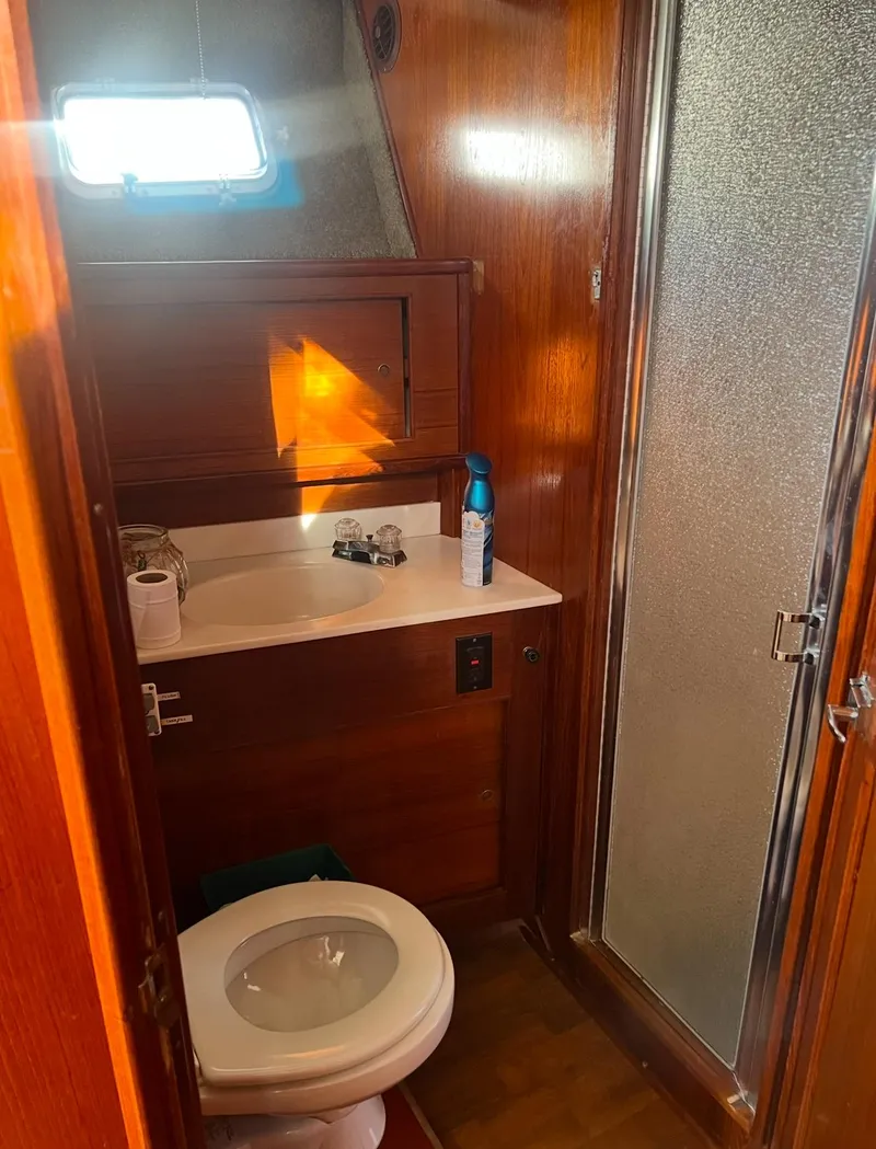Slide: The Image of 1988 Jersey 40FT Convertible yacht bathroom with wooden interior and shower. - 13