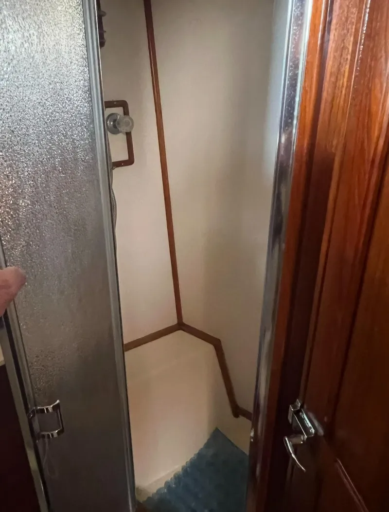 Slide: The Image of 1988 Jersey 40FT Convertible yacht shower with wooden door and compact design. - 14