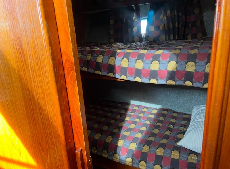Slide: The Image of Bunk beds in 1988 Jersey 40FT Convertible boat cabin with patterned bedding. - 16