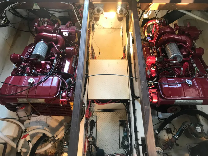 Slide: The Image of Engine room of a 1988 Jersey 40FT Convertible boat with dual red engines. - 17