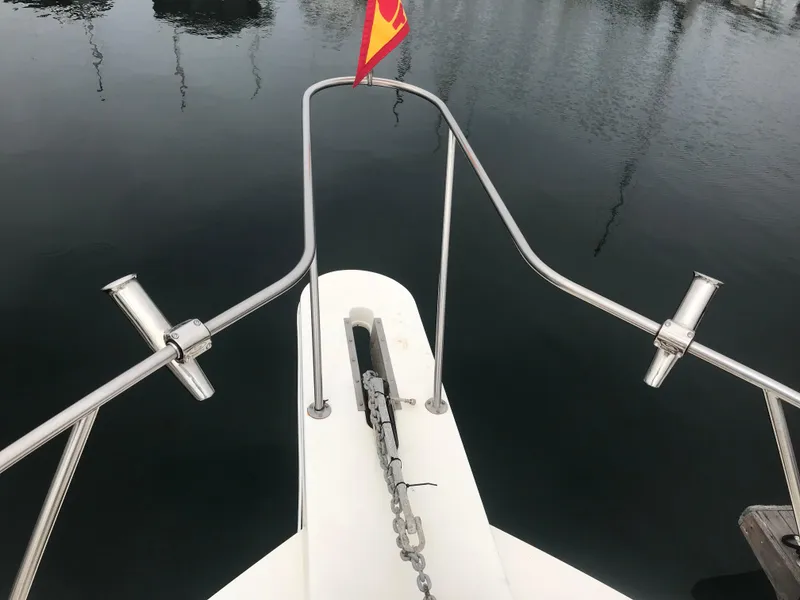 Slide: The Image of 1988 Jersey 40FT Convertible boat bow with anchor chain and flag. - 4