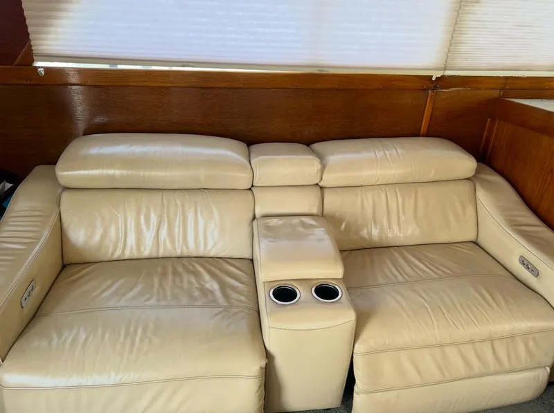 Slide: The Image of Beige leather sofa with cup holders on a 1988 Jersey 40FT Convertible. - 9