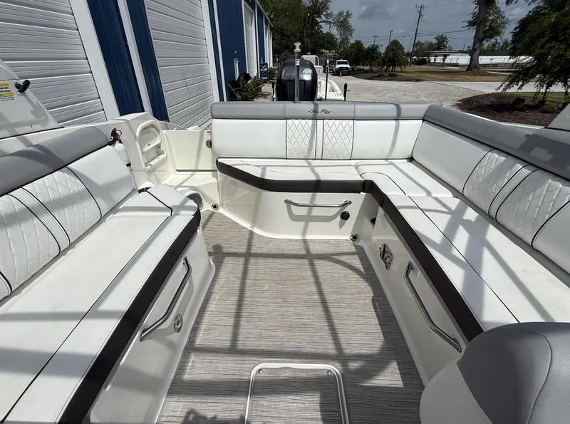 Slide: The Image of 2017 Sea Ray SDX 270 Outboard boat interior with spacious white seating and modern design. - 11