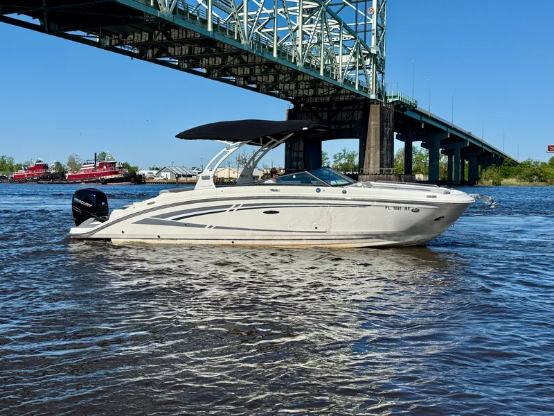 Slide: The Image of 2017 Sea Ray SDX 270 Outboard boat under a bridge on a sunny day. - 3