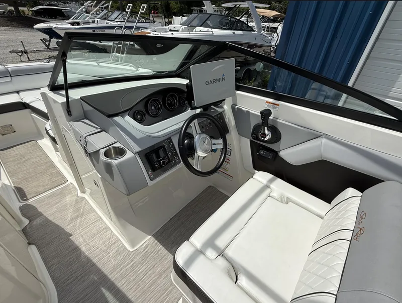 Slide: The Image of 2017 Sea Ray SDX 270 Outboard cockpit with Garmin navigation, steering wheel, and seating. - 7