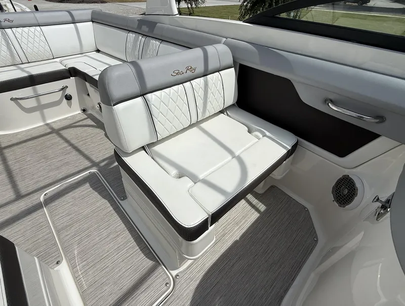 Slide: The Image of 2017 Sea Ray SDX 270 Outboard interior with white cushioned seating and elegant design. - 9
