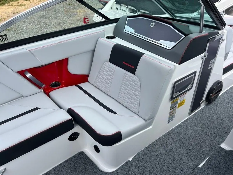 Slide: The Image of 2019 MasterCraft X22 boat interior with white and black seating, red accents, and modern design. - 8
