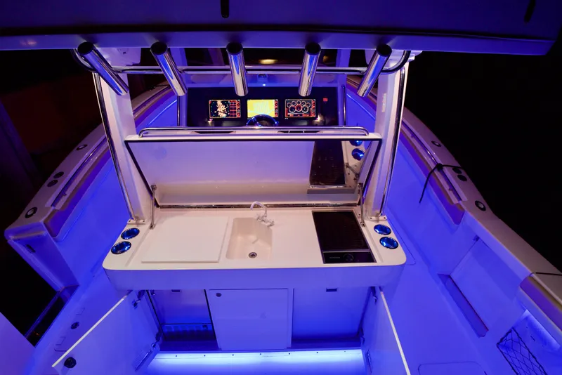 Slide: The Image of 2019 Altima 38 Xcape boat interior with illuminated control panel and modern amenities. - 10