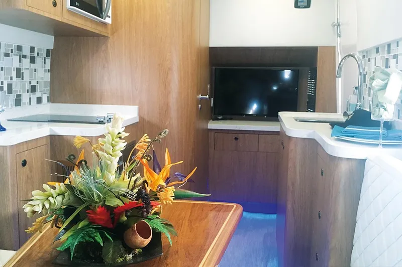 Slide: The Image of Interior of 2019 Altima 38 Xcape with modern kitchen and floral centerpiece. - 14