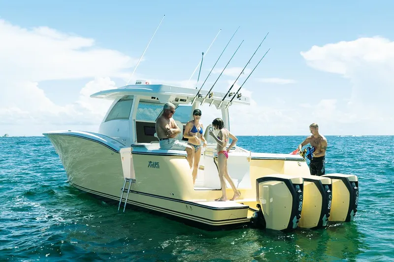 Slide: The Image of 2019 Altima 38 Xcape boat with people enjoying a sunny day on the water. - 3