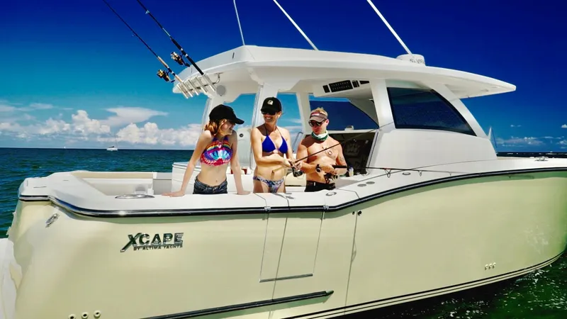 Slide: The Image of Three people enjoying fishing on a 2019 Altima 38 Xcape boat. - 5
